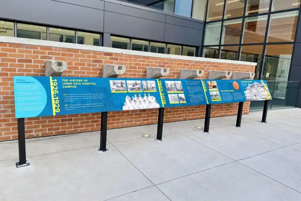 Outdoor interpretive signage displaying the Squamish Nation story of creation at Lions Gate Hospital's rooftop garden.